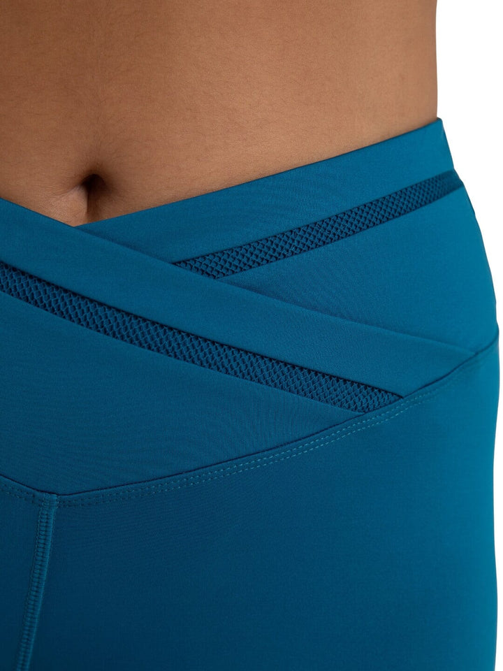 Blue athletic leggings with mesh panels on a neutral background