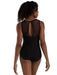 Black swimsuit with open back worn by a model on a white background