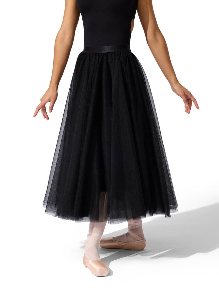 Ballerina wearing a black tulle skirt on a white background