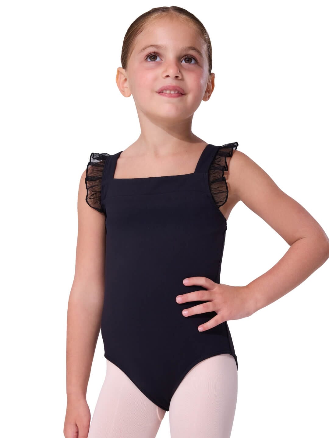 Young girl wearing a black leotard with sheer sleeves on a white background