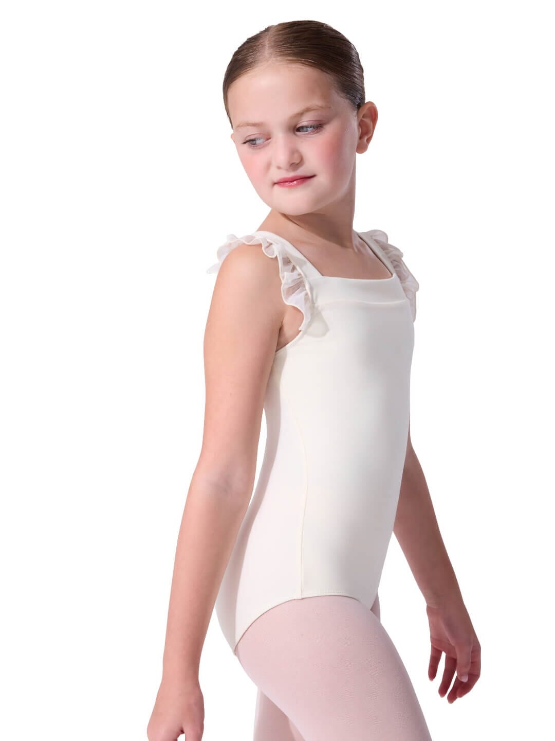 Young girl wearing a white sleeveless leotard with ruffled shoulders on a white background