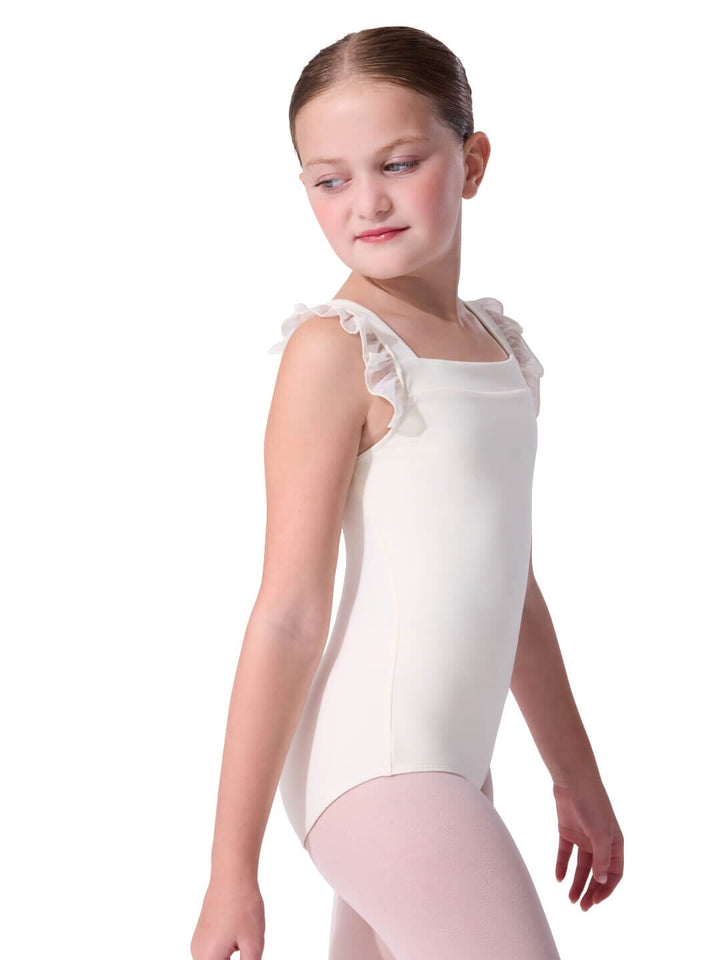 Young girl wearing a white sleeveless leotard with ruffled shoulders on a white background