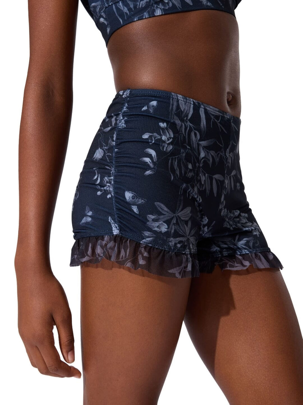 Navy floral shorts worn by a person on a white background