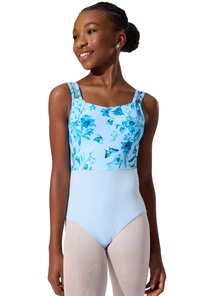 Woman wearing a blue floral leotard with a white background