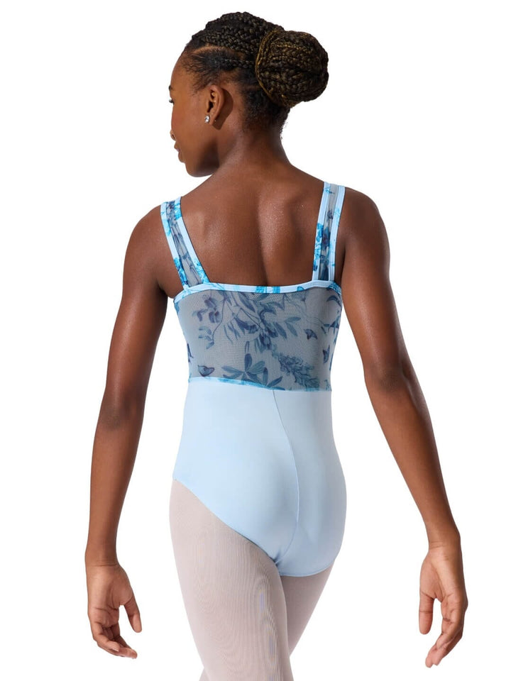 Ballet dancer wearing a blue and white leotard with floral pattern on a white background
