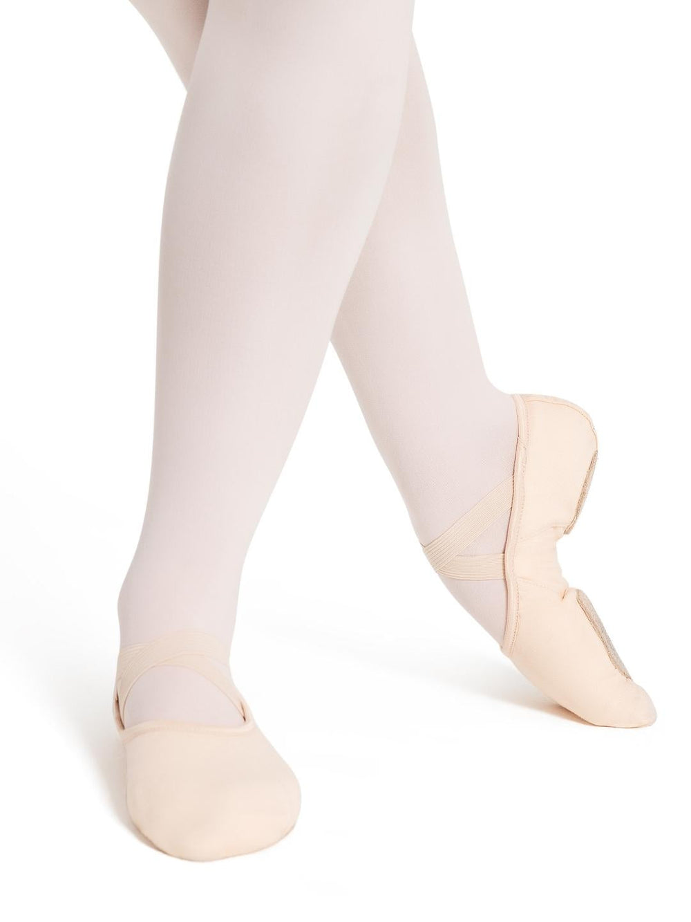 Ballet shoes worn with white tights on a white background