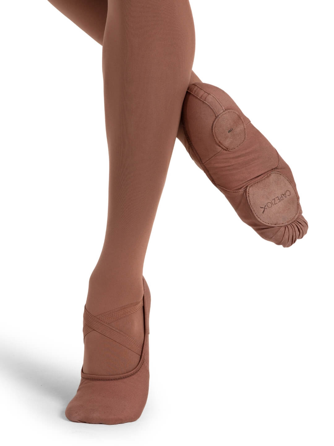 Brown ballet shoes worn with tights on a white background