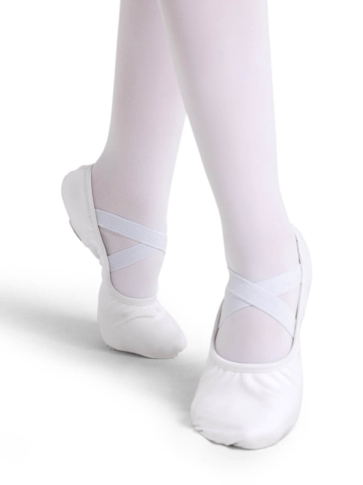 White ballet shoes worn with white tights on a white background