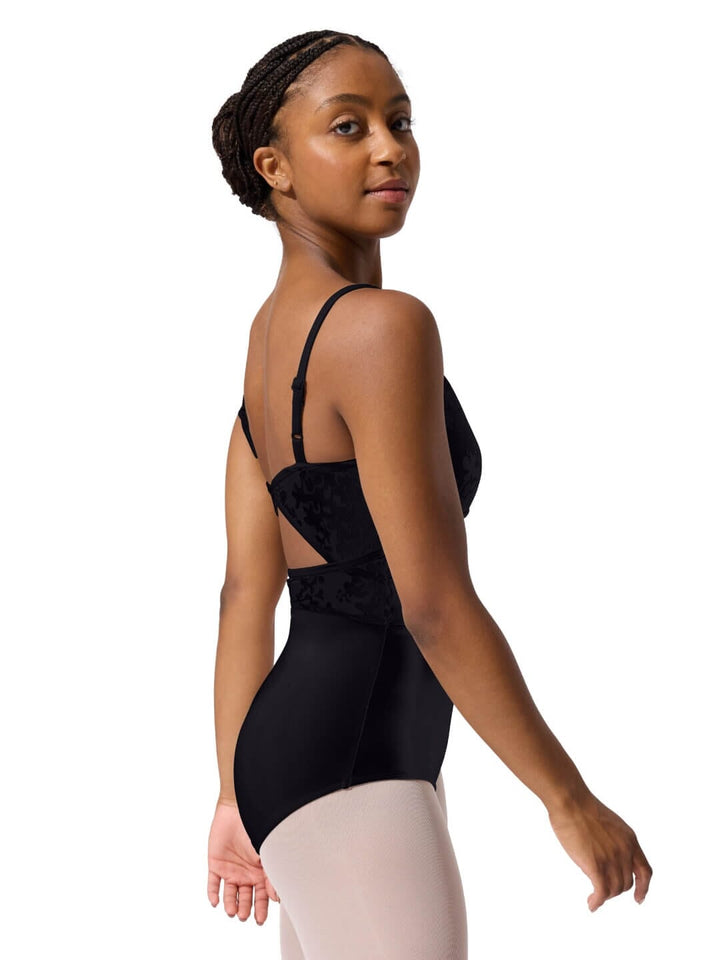 Woman wearing a black leotard with a white background