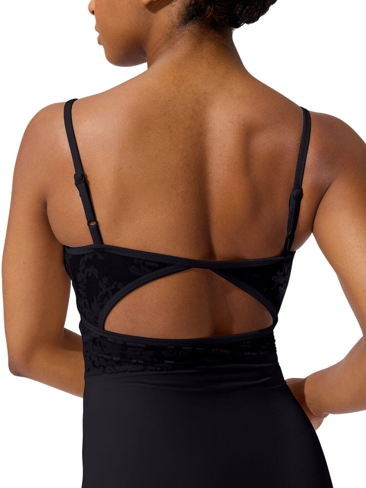 Black strappy top worn by a person on a white background