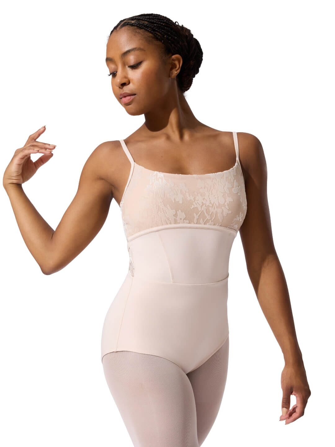 Woman wearing a beige bodysuit on a white background