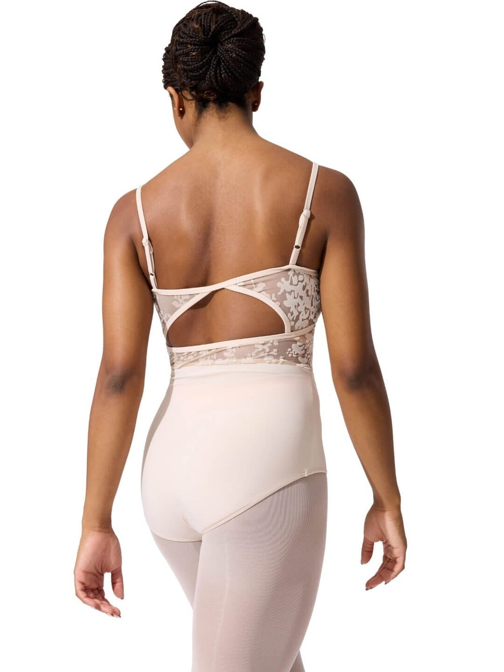 Woman wearing a beige bodysuit with lace detailing on a white background