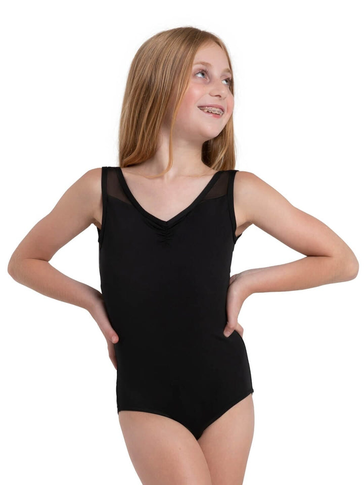 Young girl wearing a black leotard on a white background