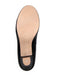 Black shoe sole with beige insole on a white background