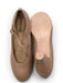 Pair of brown ballet flats with 'Capezio' branding on a white background