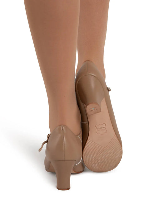 Pair of beige high-heeled shoes on a white background