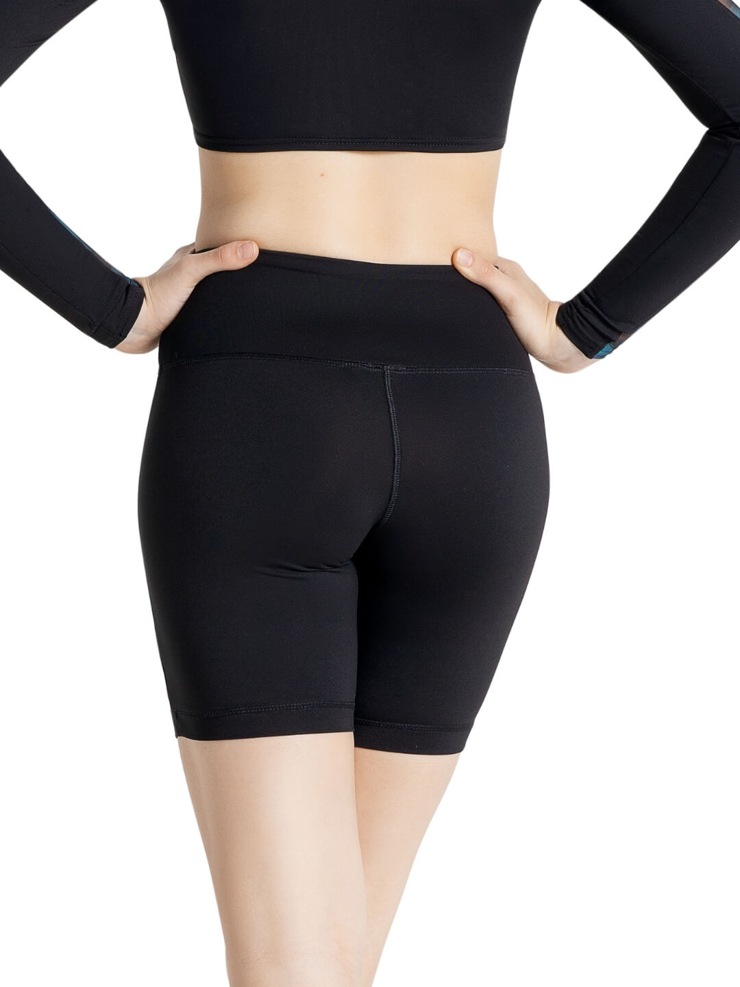 Person wearing black athletic shorts on a white background