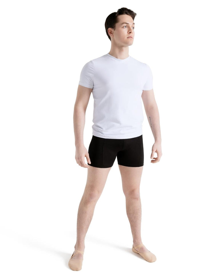 Man wearing a white t-shirt and black shorts on a white background