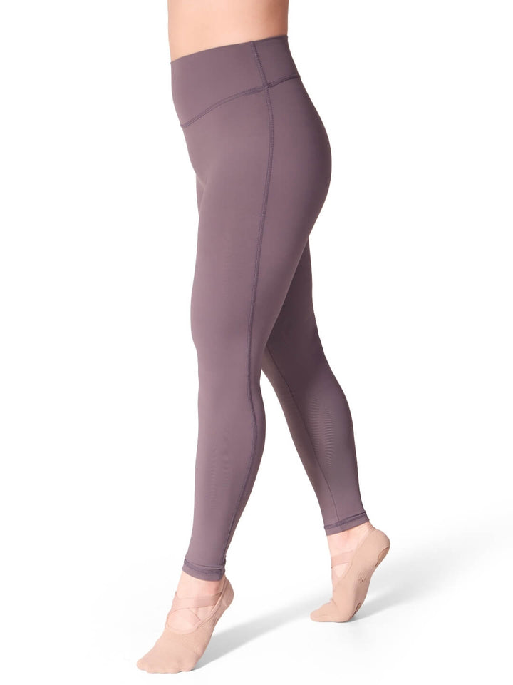 Purple leggings worn by a person on a white background