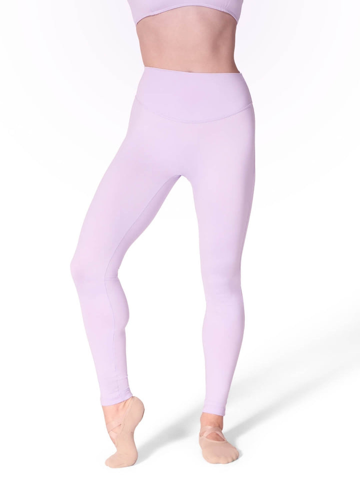 Person wearing lavender leggings on a white background