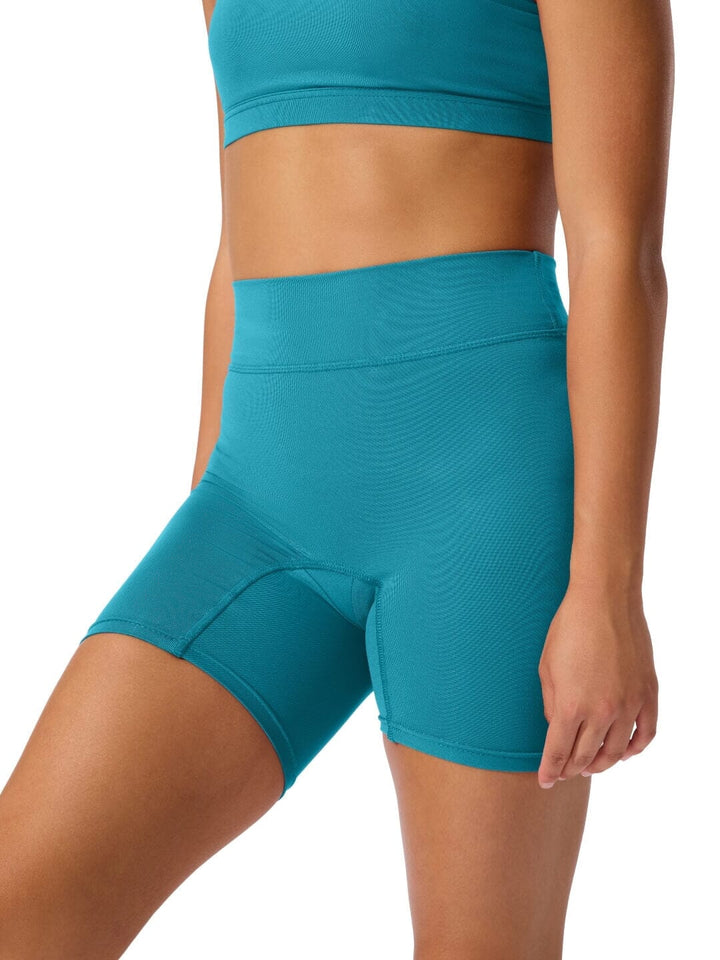 Teal athletic shorts worn by a person on a white background