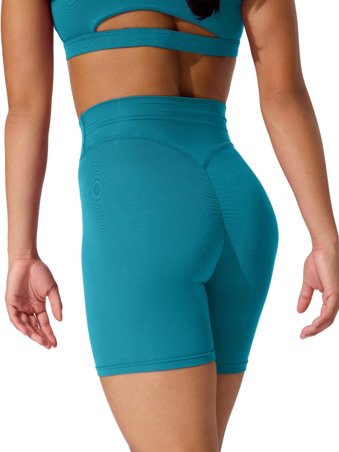 Teal athletic shorts worn by a person on a white background