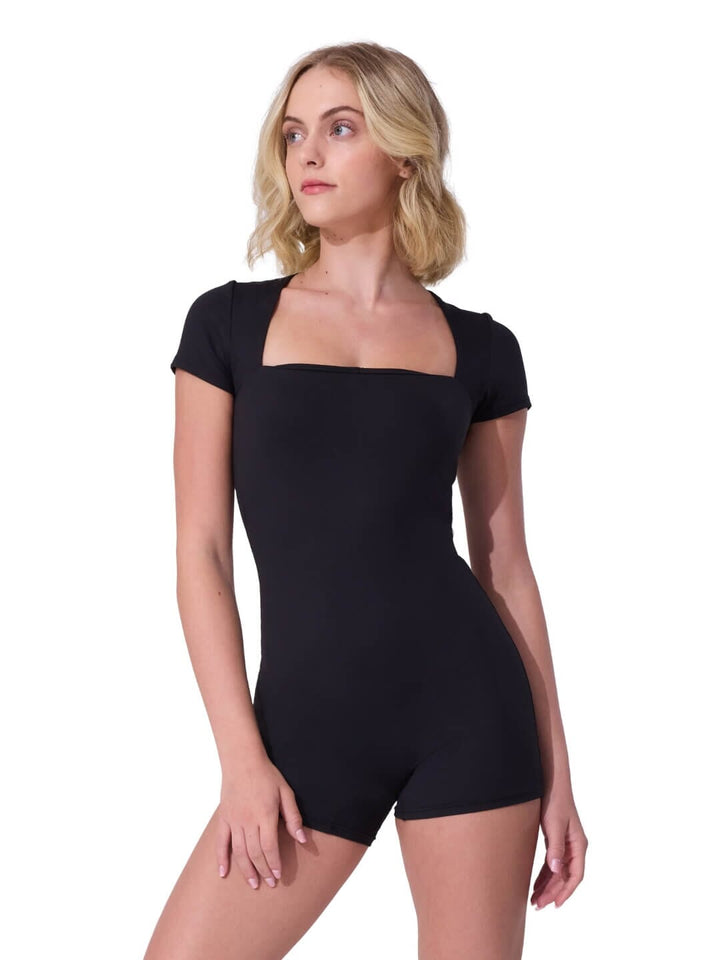 Woman wearing a black bodysuit on a white background
