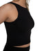 Black tank top worn by a person on a white background