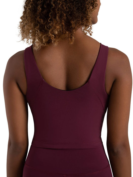 Person wearing a maroon tank top on a white background