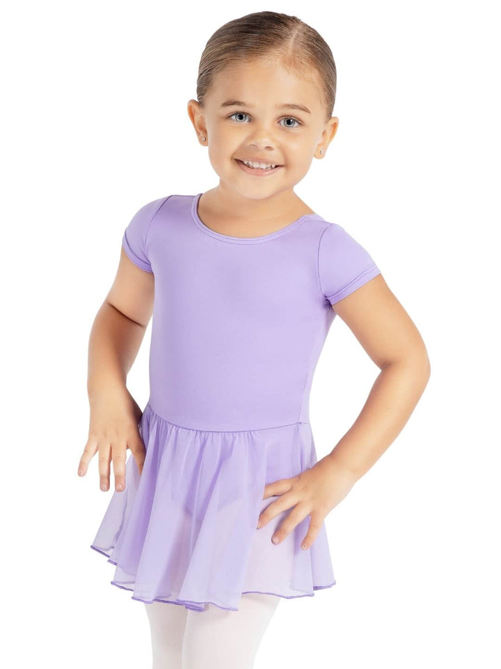 Young girl wearing a purple dress on a white background