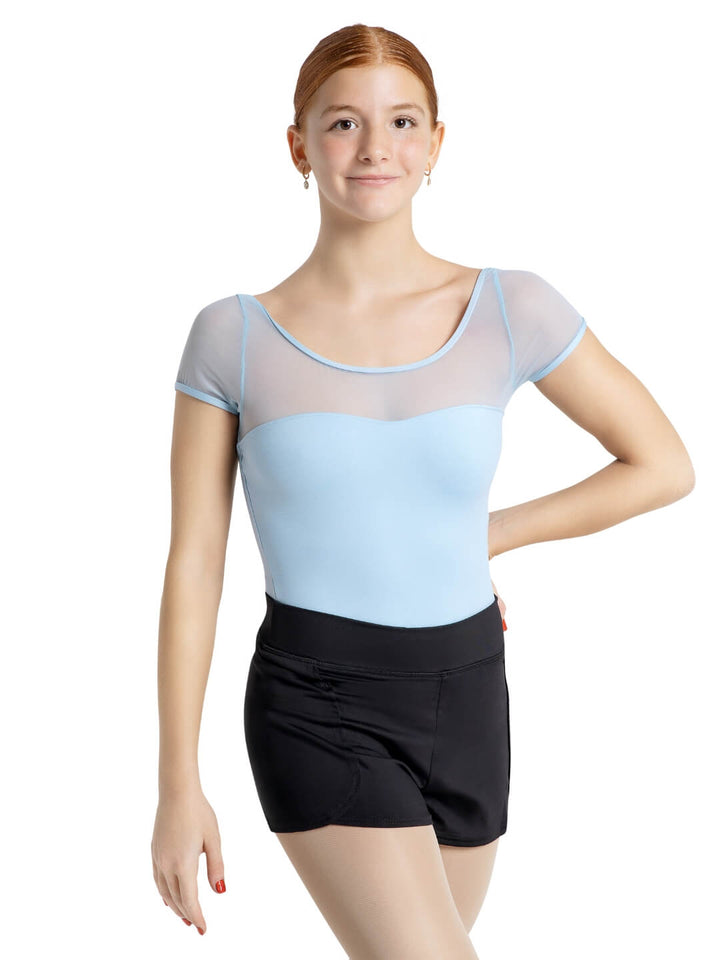 Person wearing a light blue and gray top with a black skirt on a white background