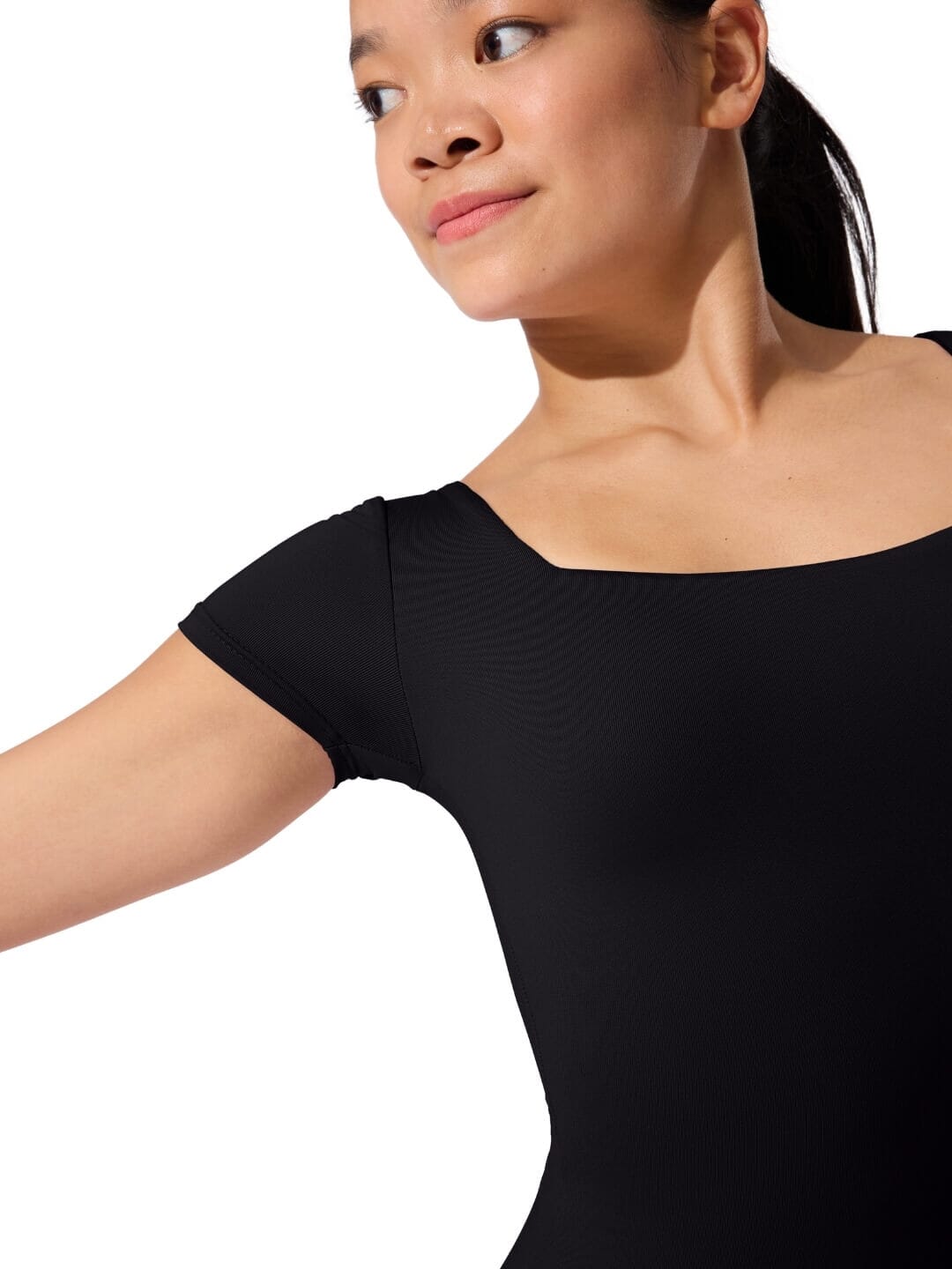 Woman wearing a black leotard on a white background