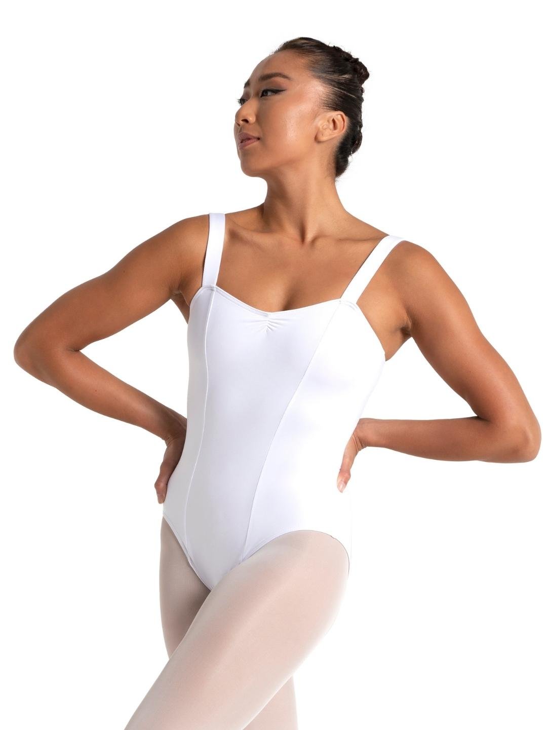 Woman wearing a white leotard and beige tights on a white background