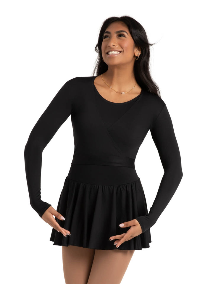Woman wearing a black long-sleeve dress with a white background