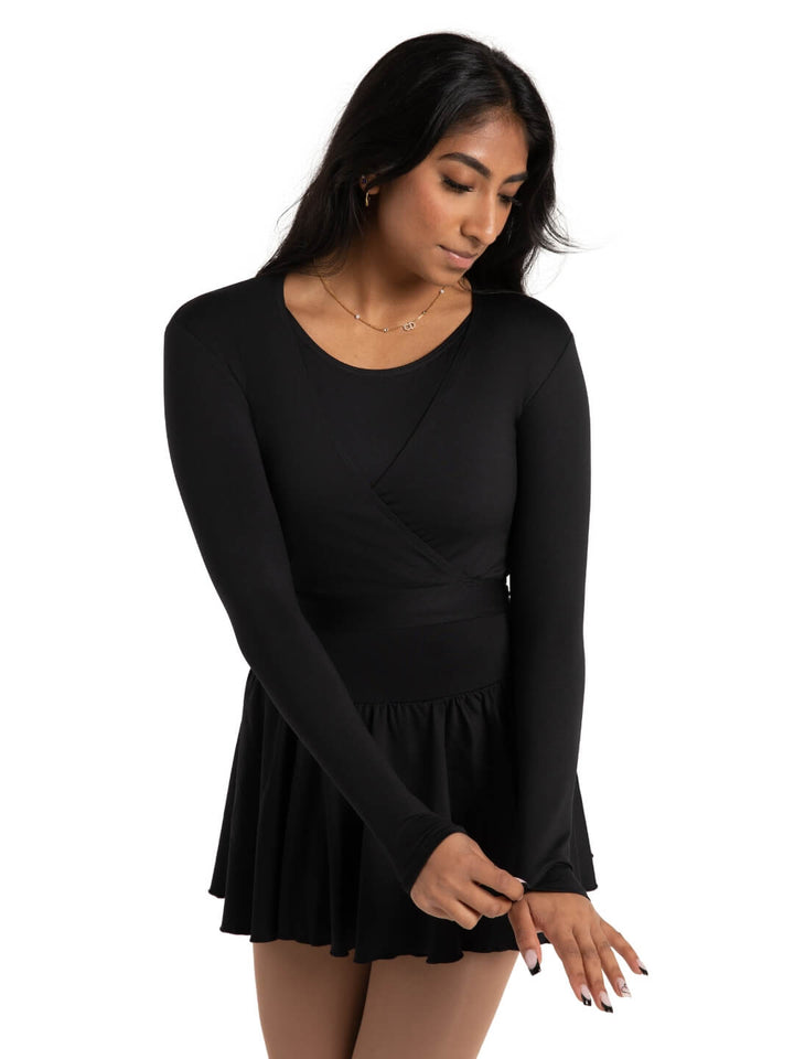 Woman wearing a black long-sleeve dress on a white background