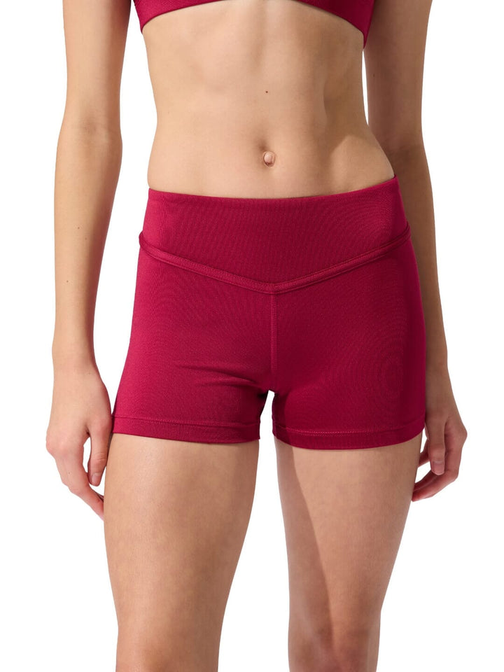 Red athletic shorts worn by a person on a white background