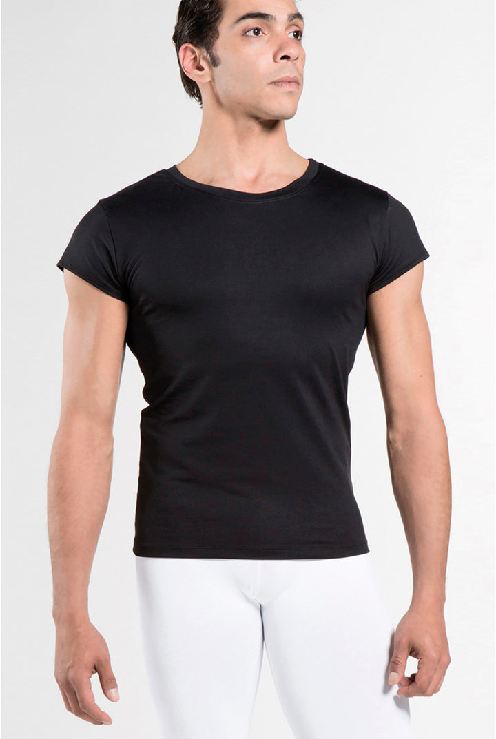 Man wearing a black t-shirt and white pants on a white background