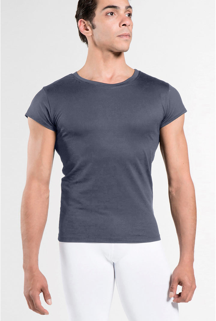 Man wearing a dark gray t-shirt and white pants on a white background