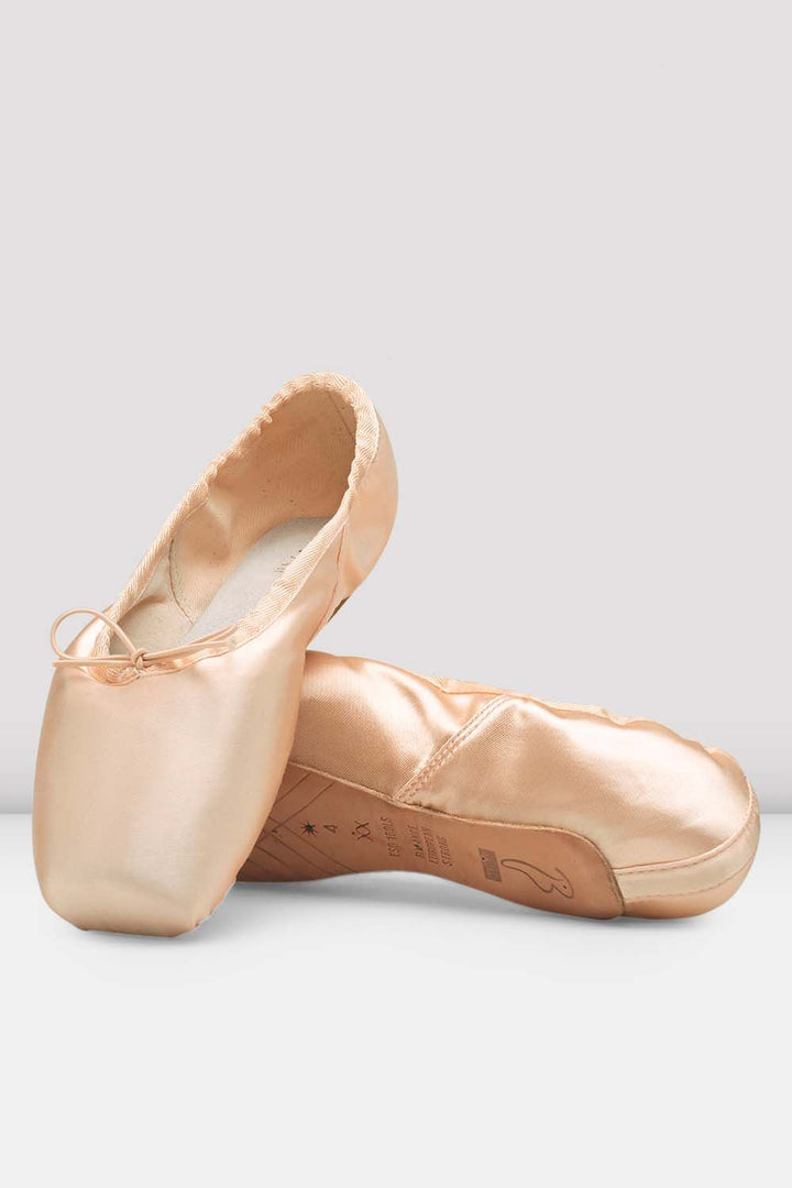 Pair of pink ballet shoes on a light gray background