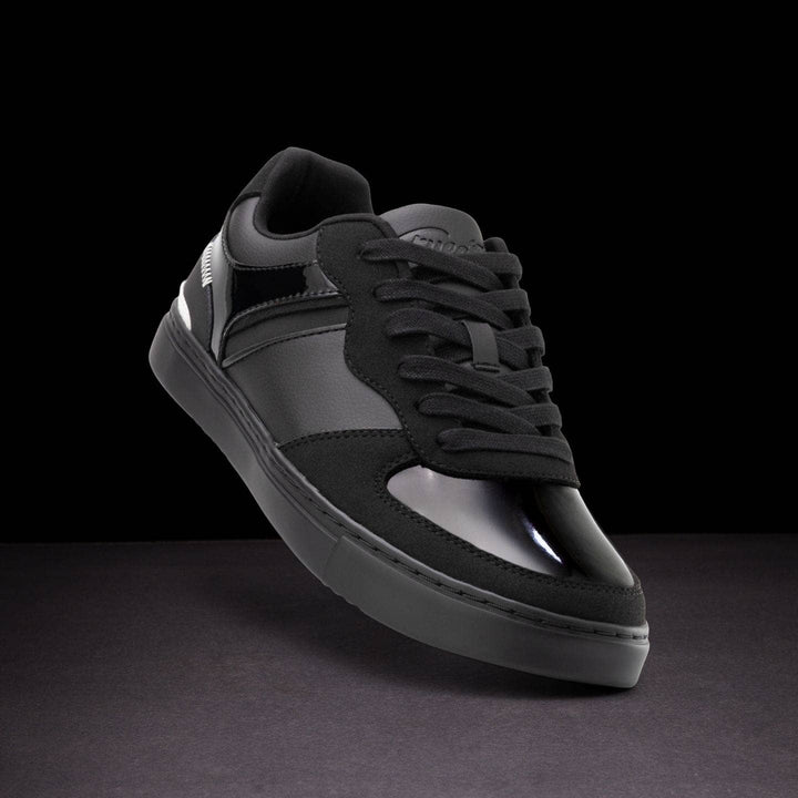Black and gray sneaker on a dark background