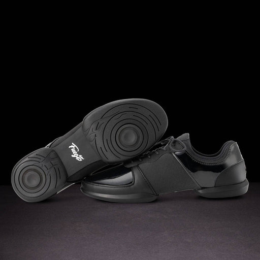 Black dance shoes with a visible brand logo on a dark background