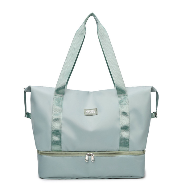 Light blue tote bag with a visible brand label on a white background