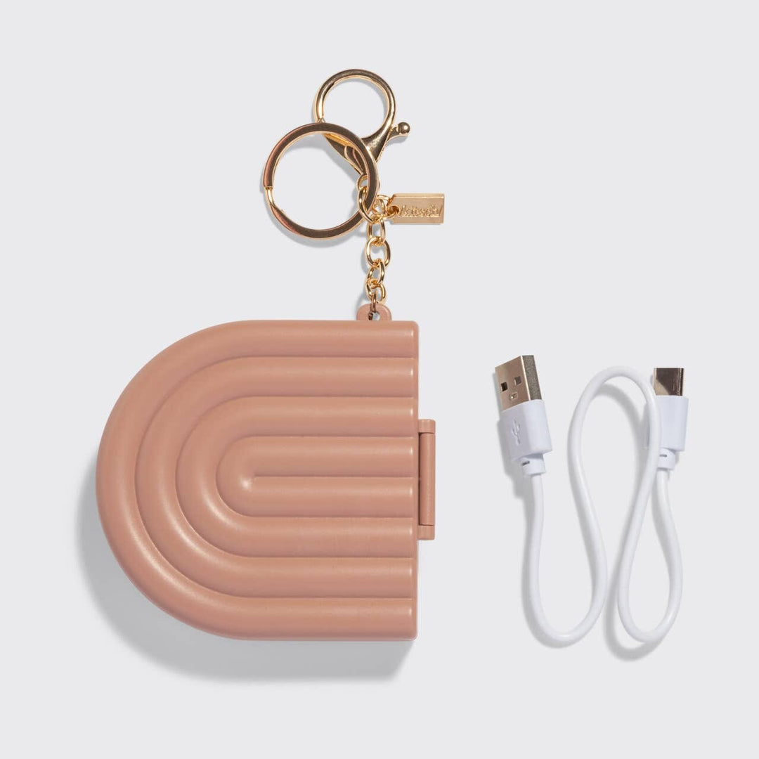 Pink case with keychain and USB cable on a light gray background