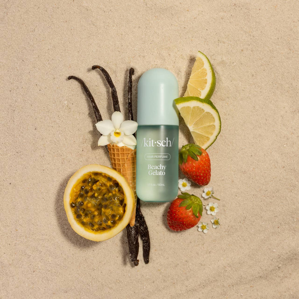 Kitsch product with vanilla beans, lemon slices, strawberries, and a flower on a beige background