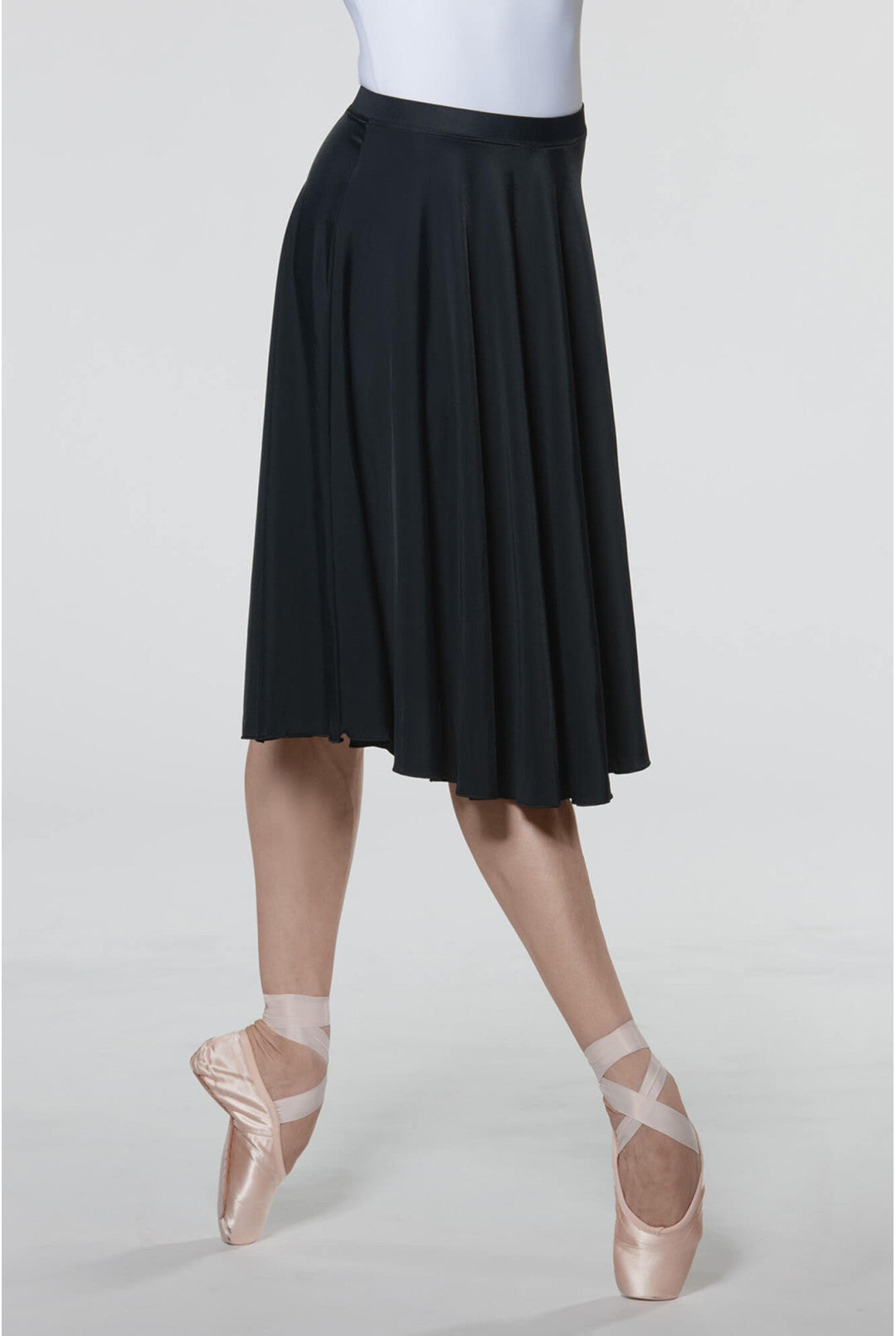 Black ballet skirt worn by a dancer on a white background
