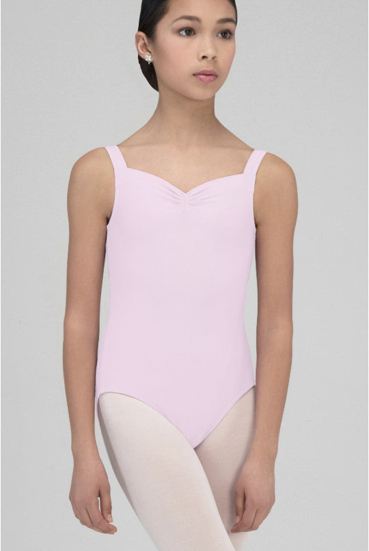 Young girl wearing a pink leotard on a gray background