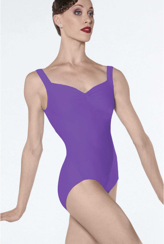 Woman wearing a purple leotard on a white background