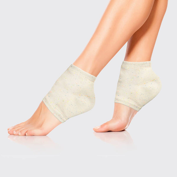 Beige ankle support wraps on a person's feet against a light gray background