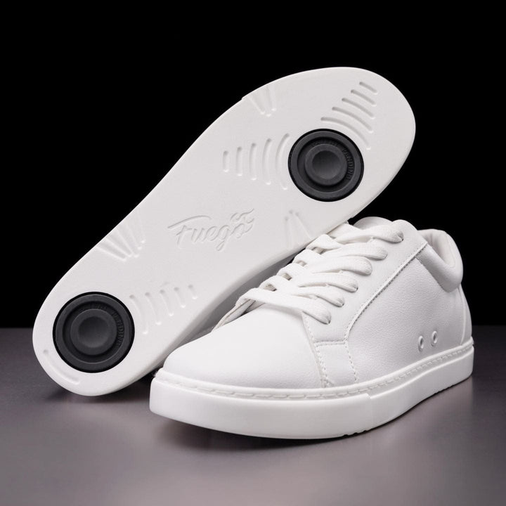 A pair of white low-top dance sneakers with a view of the soles, showcasing the brand name 'Fuego' and the signature flame design.