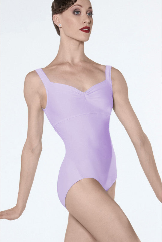 Woman wearing a lavender leotard on a white background